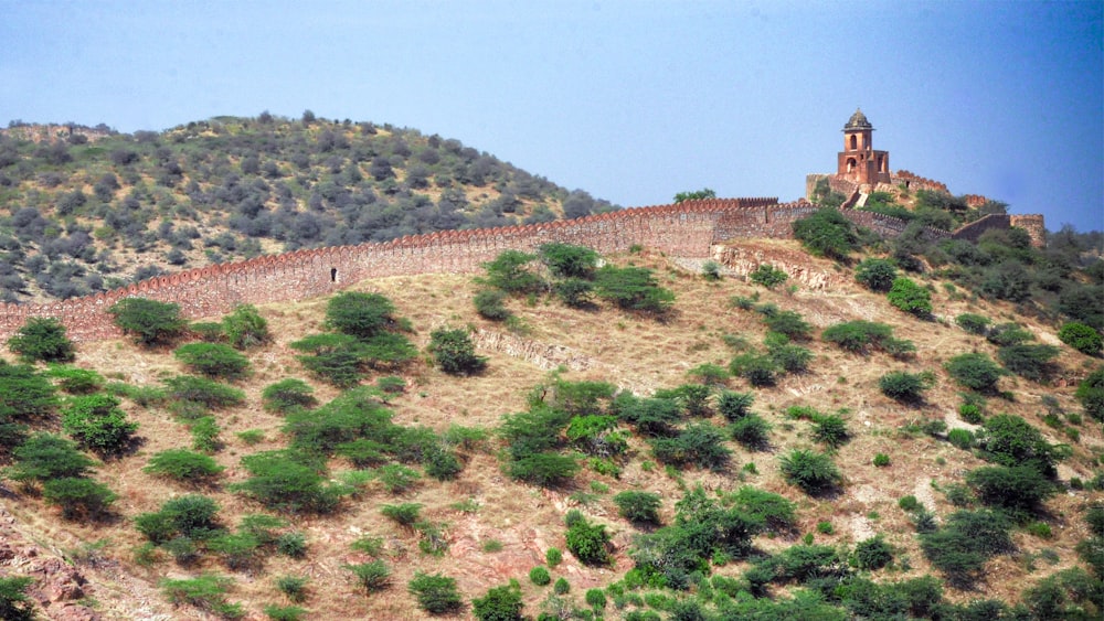 a very tall building sitting on top of a hill