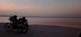 Close-up of a Honda Activa 6G with the golden sands of Puri Beach behind it.