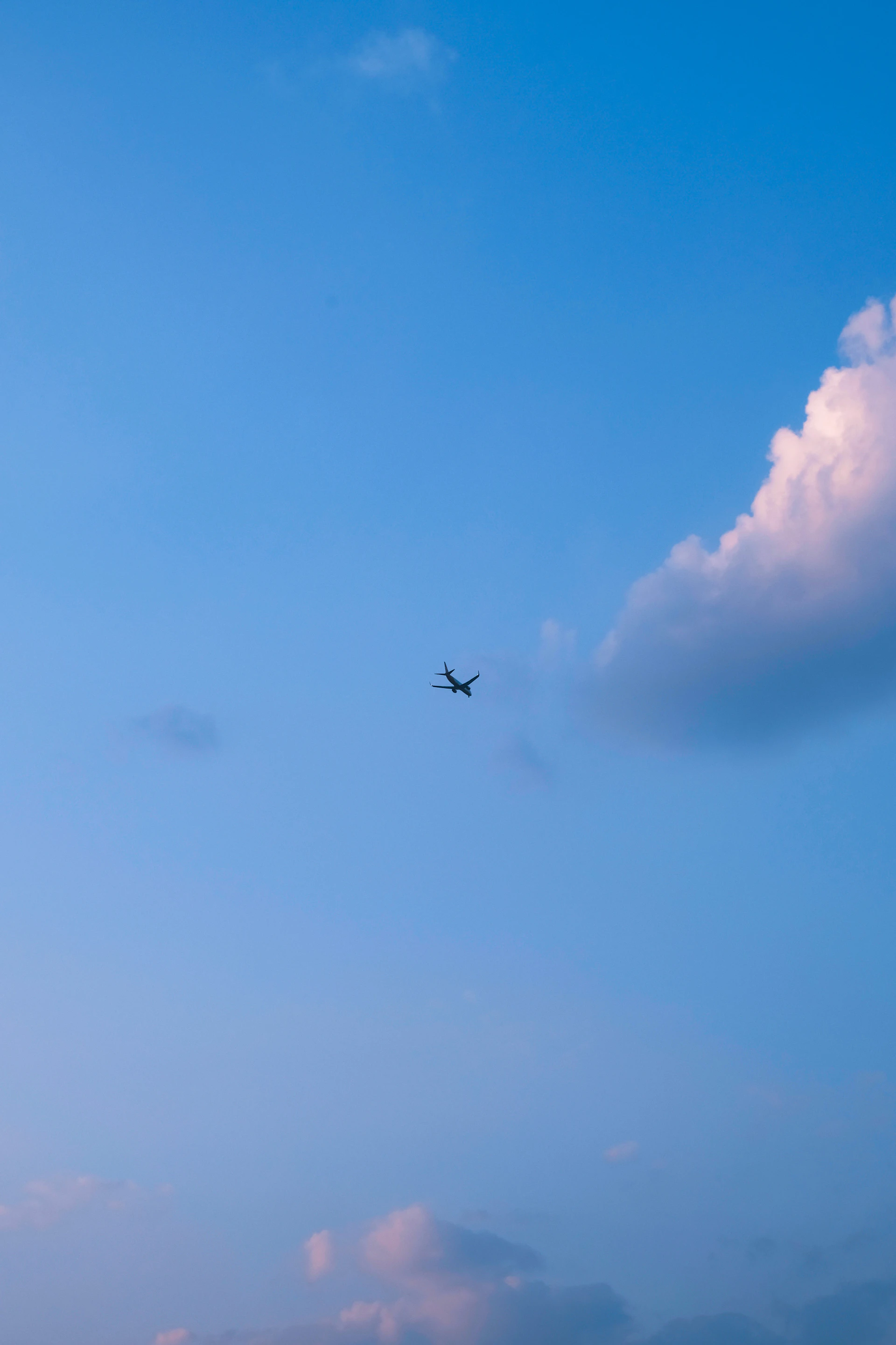 an airplane is flying in the blue sky