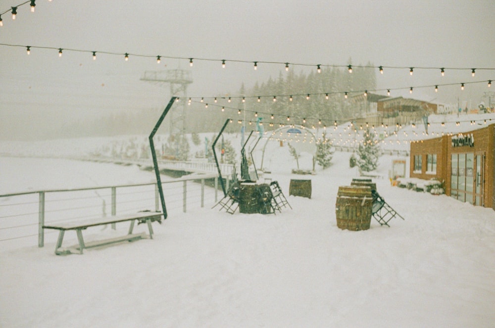 a snow covered field with a ski lift in the background