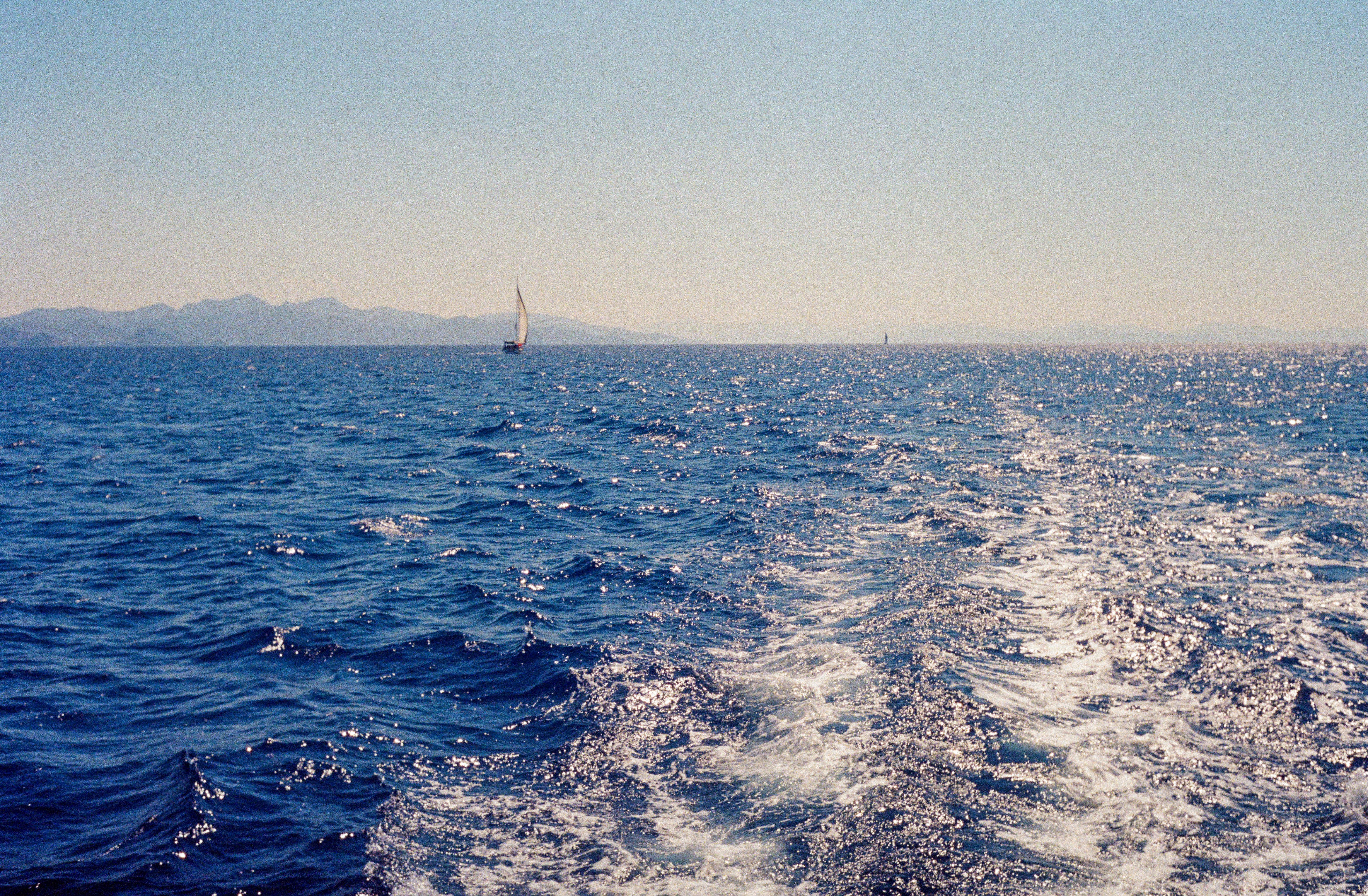 A view of the back of a boat in the ocean photo – Free Sea Image on ...