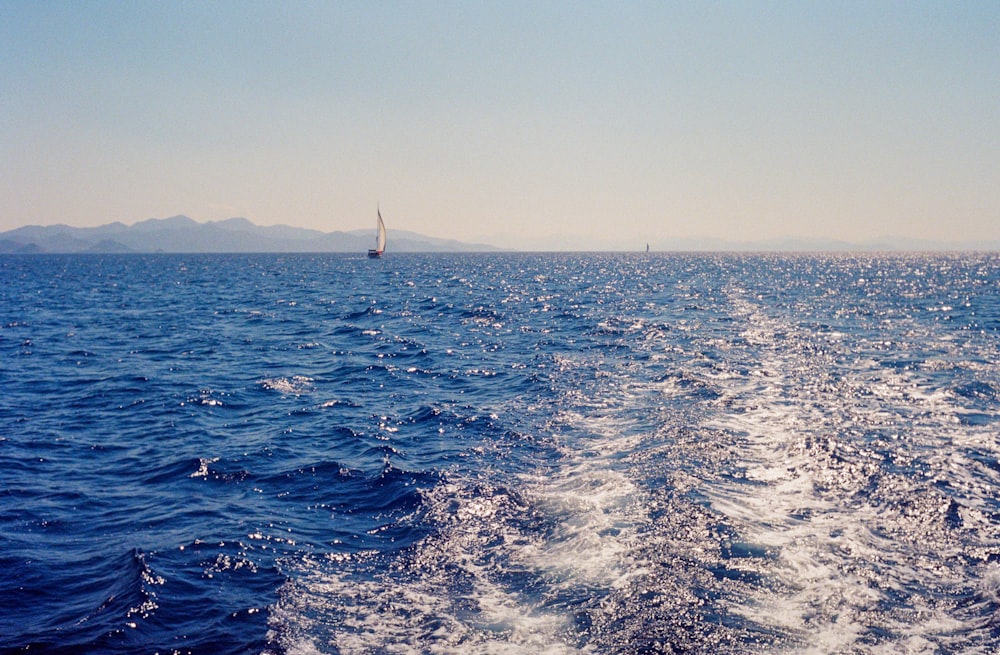 a view of the back of a boat in the ocean