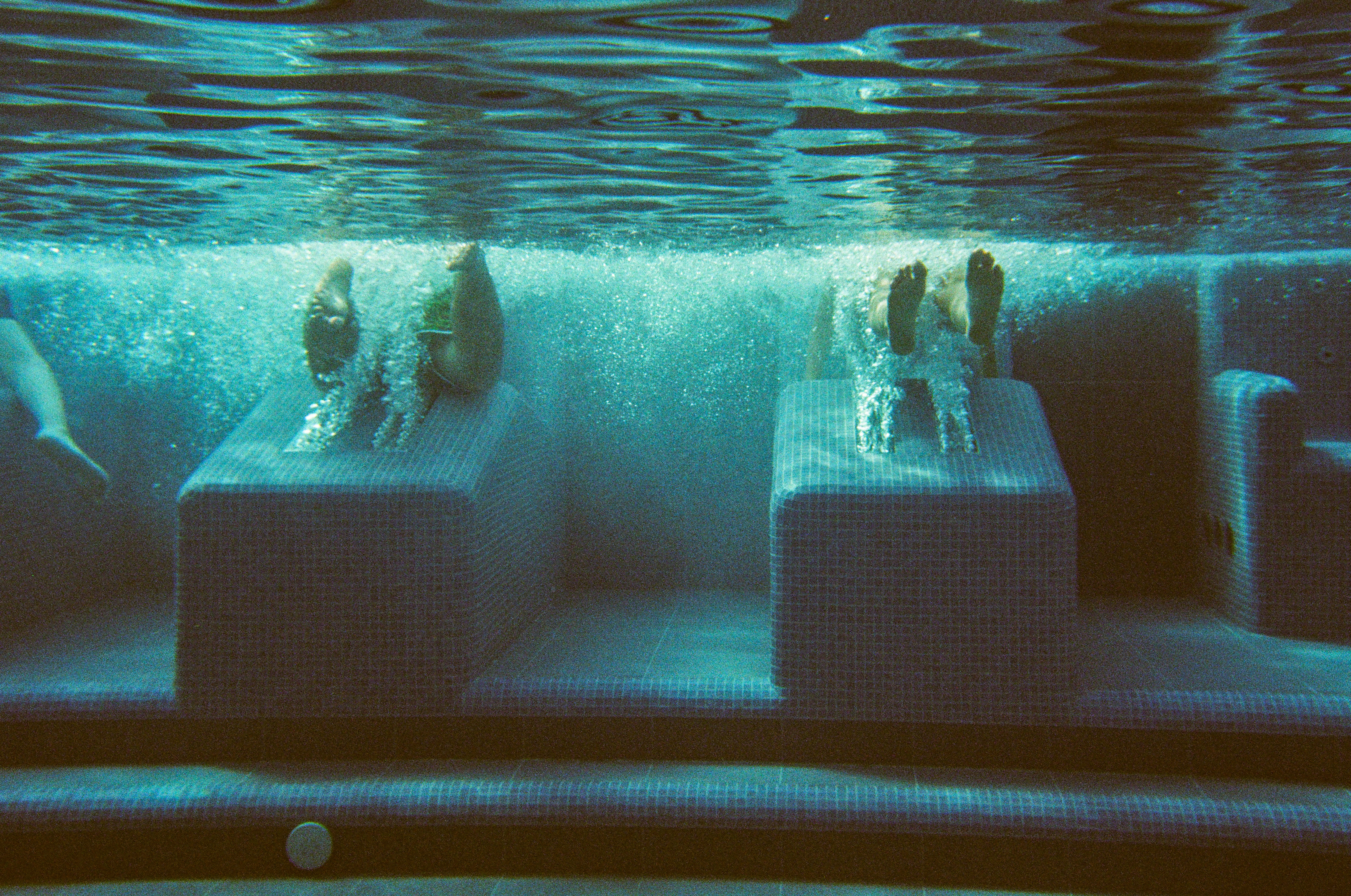 a group of people are swimming in a pool