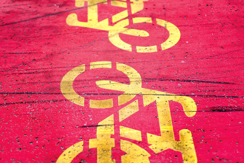 a close up of a street sign painted on the ground