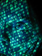 a close up of a person's face in front of a computer screen