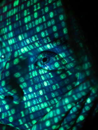 a close up of a person's face in front of a computer screen