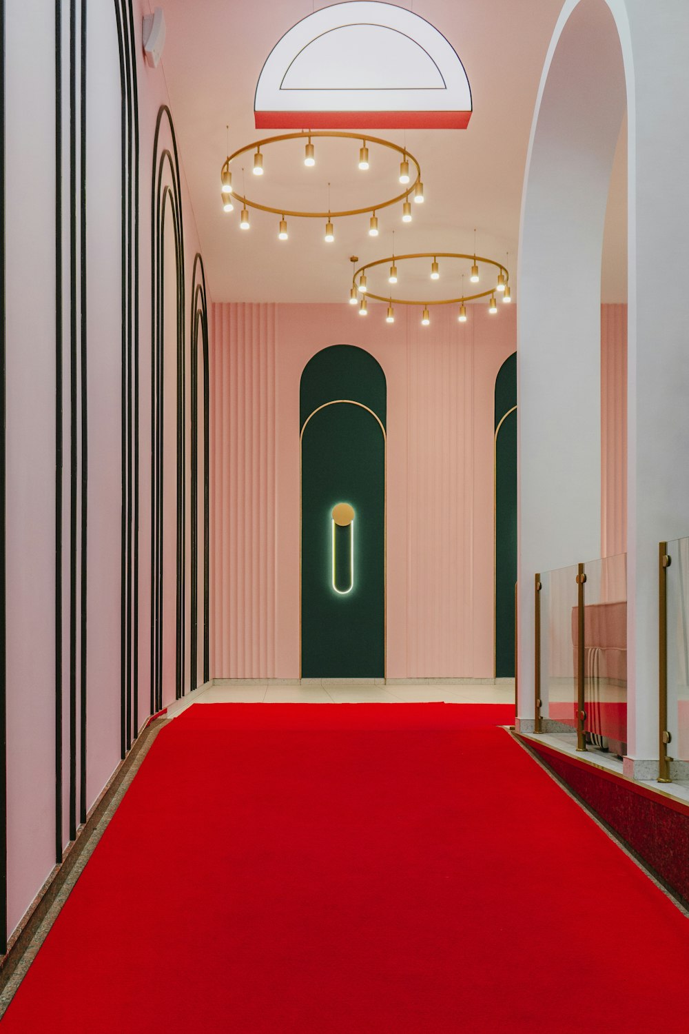 a red carpeted hallway leading to a doorway