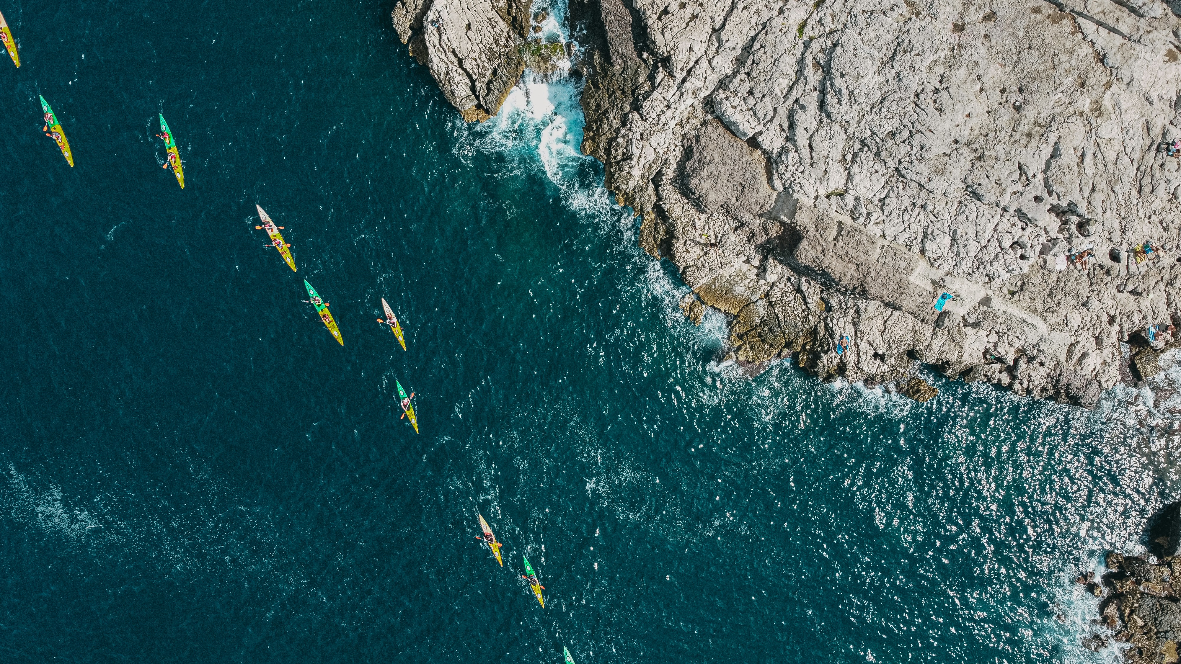 a group of people riding kayaks on top of a body of water