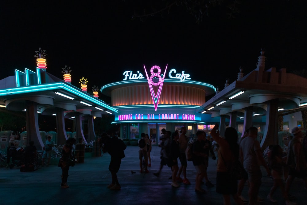 a group of people standing outside of a building at night