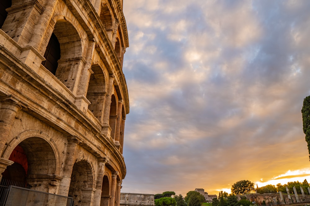 the sun is setting over the roman colossion