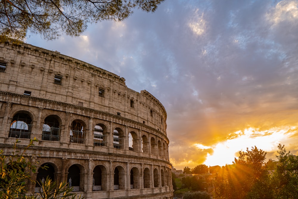 the sun is setting over the roman colossion