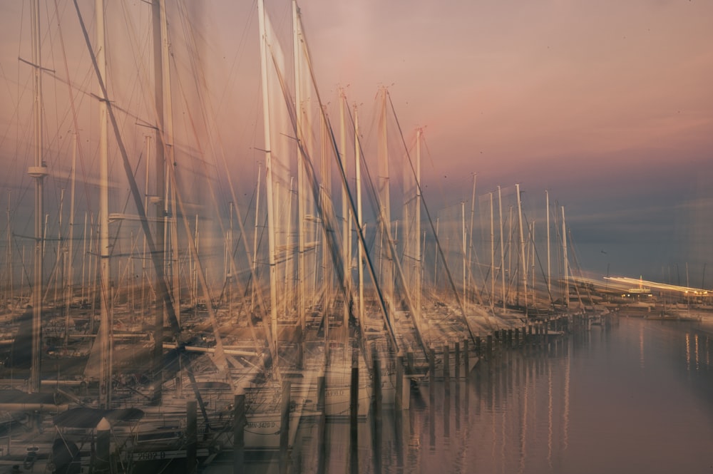 a bunch of sailboats are docked in a harbor