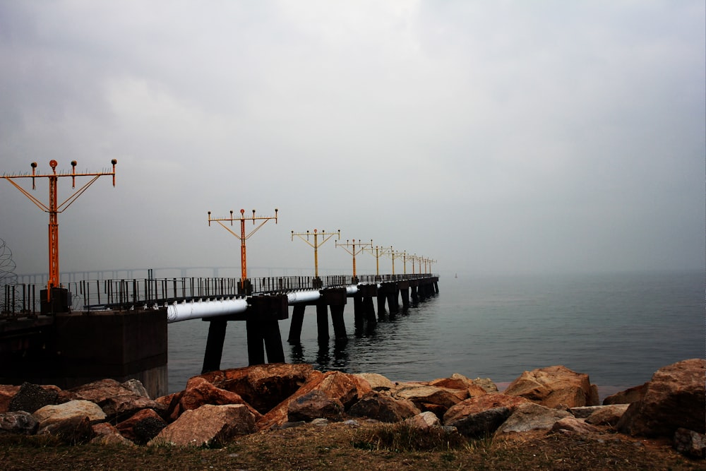a long pier on a foggy day by the ocean