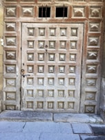Patterned entryway panels adding a welcoming touch to a rustic wooden door.