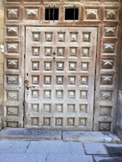 A sturdy wooden garage door with intricate paneling, showcasing expert craftsmanship.