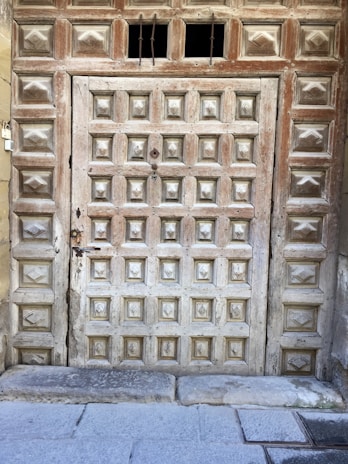 A sturdy wooden garage door with intricate paneling, showcasing expert craftsmanship.