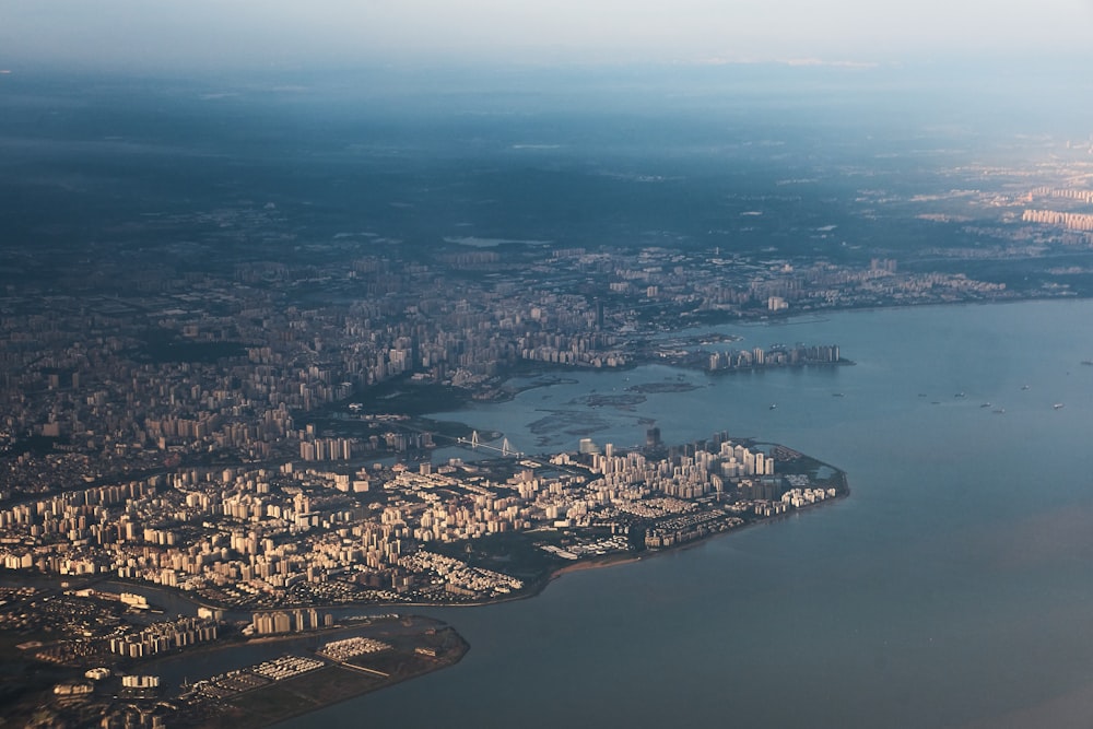 an aerial view of a city and a body of water