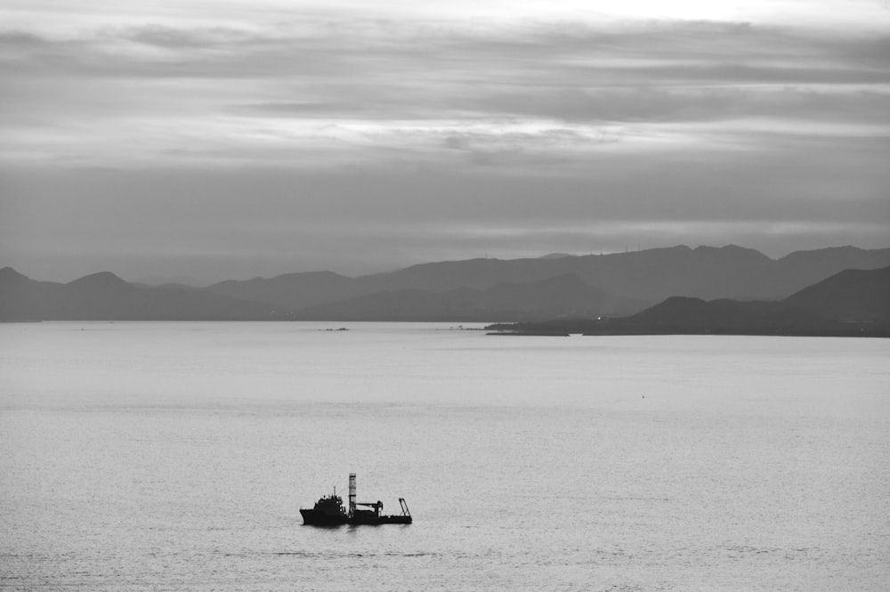 a small boat floating on top of a large body of water