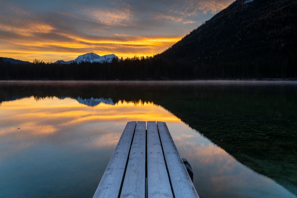 a wooden dock sitting in the middle of a lake