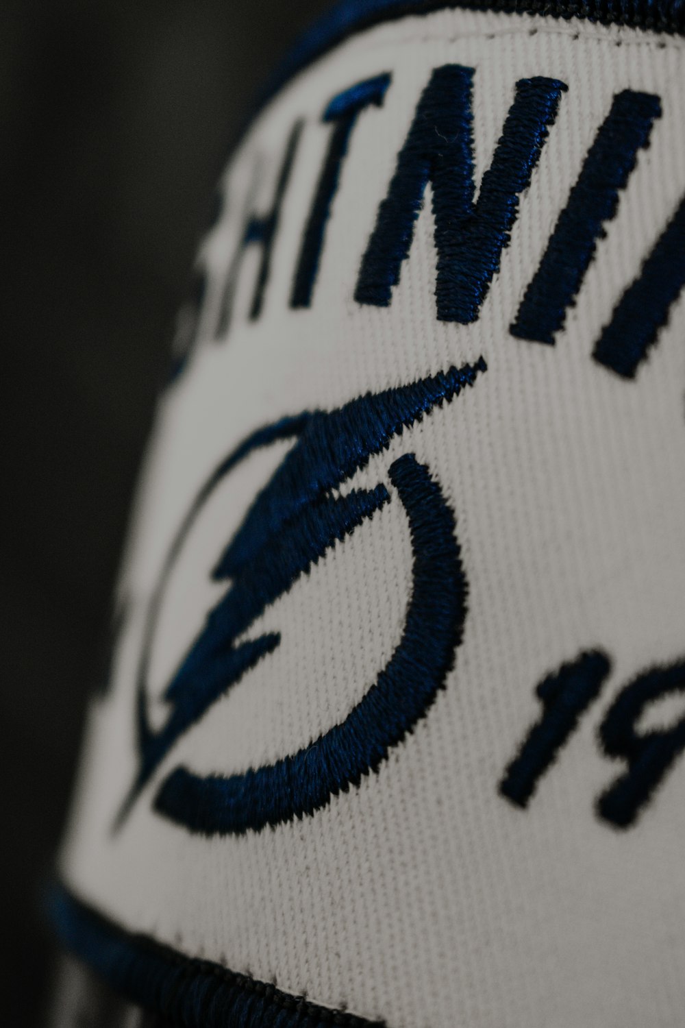 a close up of a white and blue hat