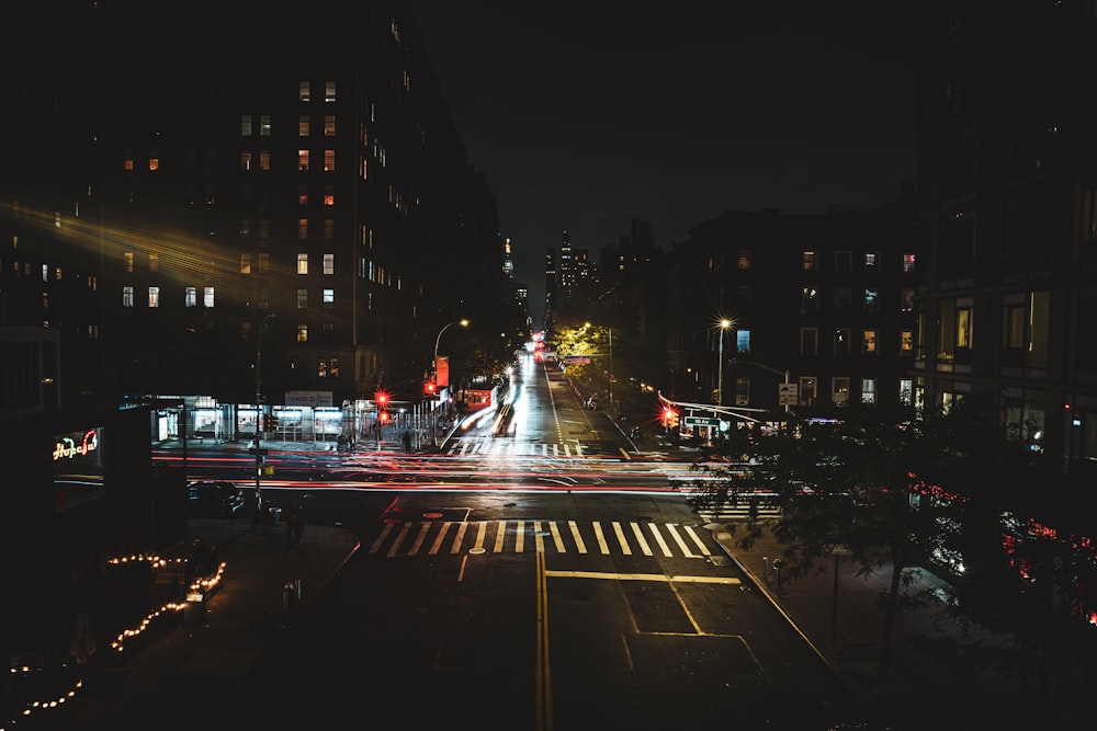 a city street at night with traffic lights