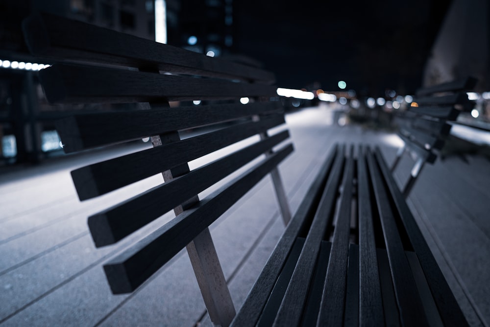 a close up of a park bench at night