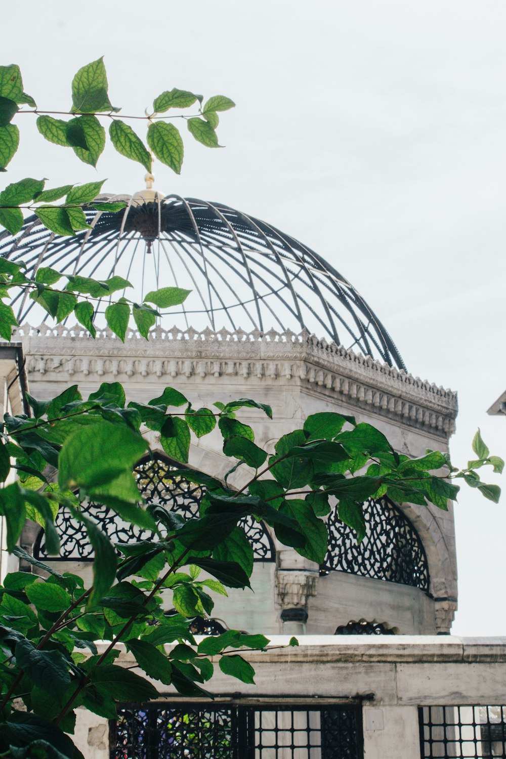 a building with a dome and a fence around it