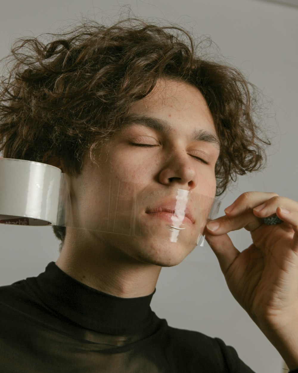 a man holding a cup of coffee to his face