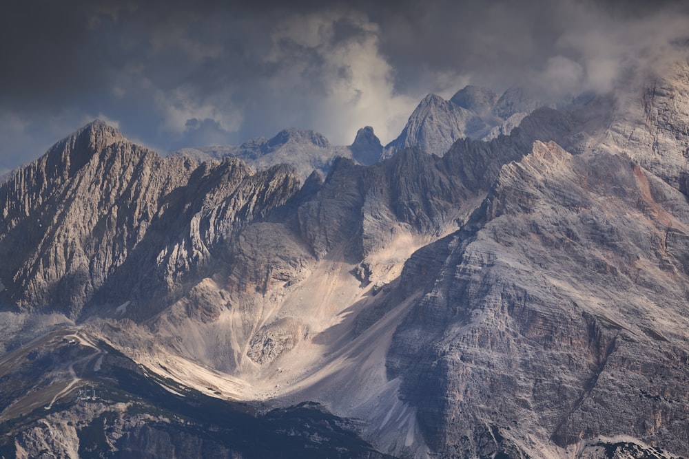 a very tall mountain with some clouds in the sky