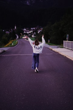 a person jumping in the air on a street