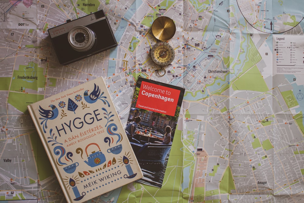 a map, a camera, and a book on a table