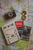 a map, a camera, and a book on a table