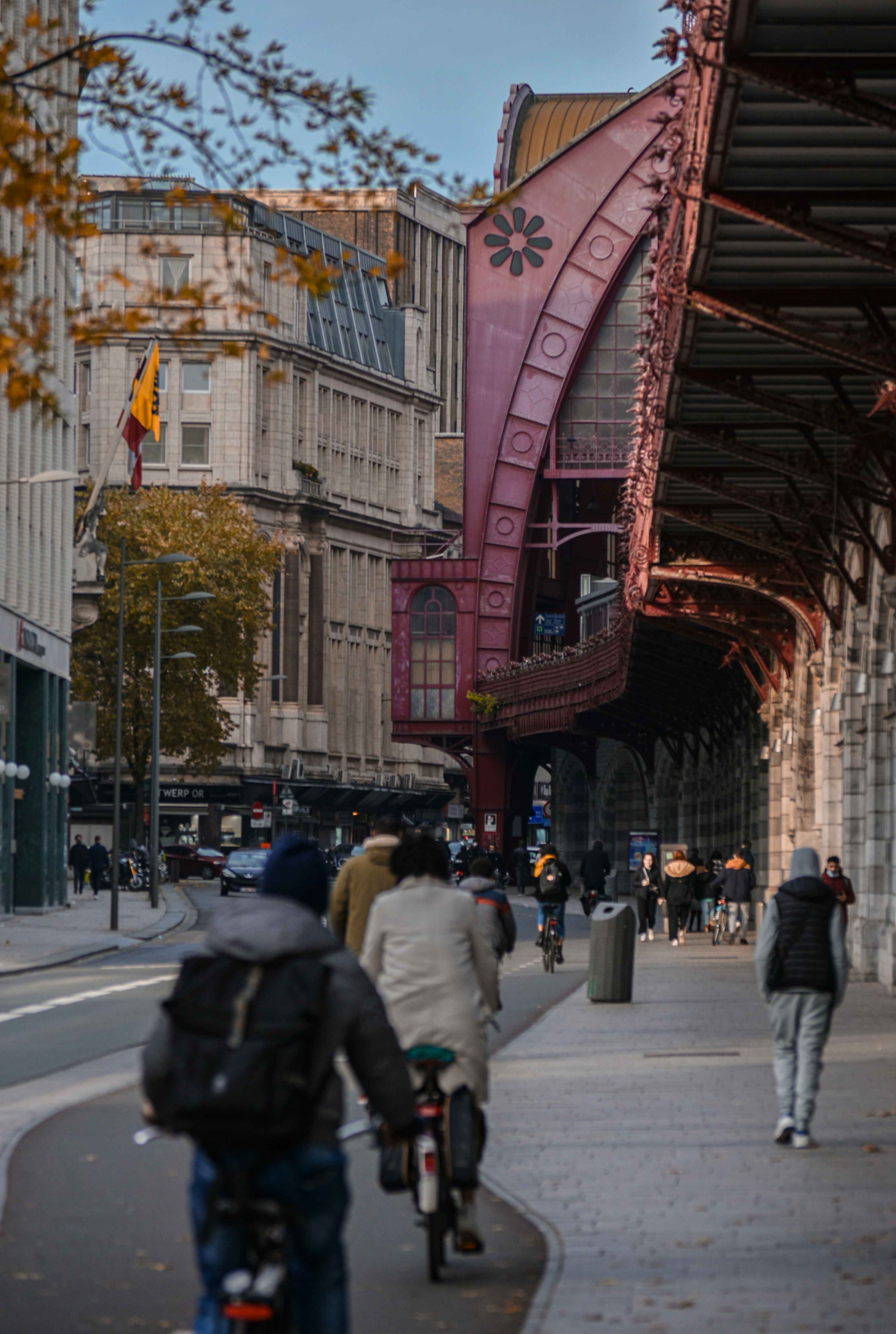 a man riding a bike down a street next to tall buildings