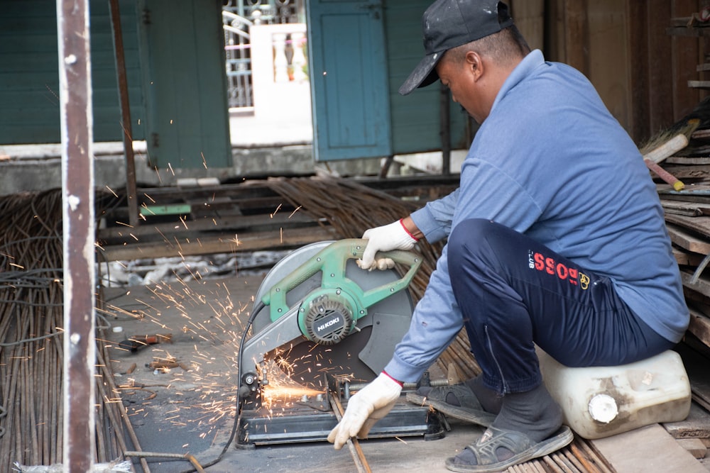 a man grinding metal with a grinder