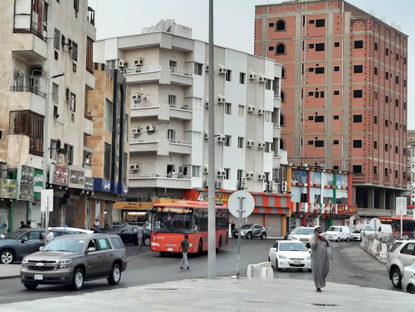 The bustling streets of Kumasi with colorful buildings and busy traffic.