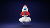 a red and white toy rocket on a blue background