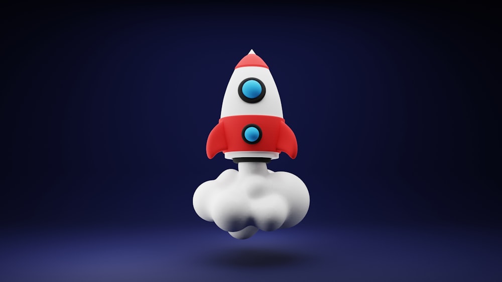 Un cohete de juguete rojo y blanco sobre un fondo azul