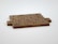 Wooden Scrabble tiles are arranged to form the phrase 'TRUE LOVE NEEDS WORK' on a light surface.