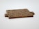 Wooden Scrabble tiles are arranged to form the phrase 'TRUE LOVE NEEDS WORK' on a light surface.