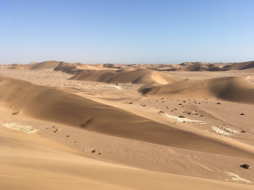 sand dunes in the desert under a blue sky