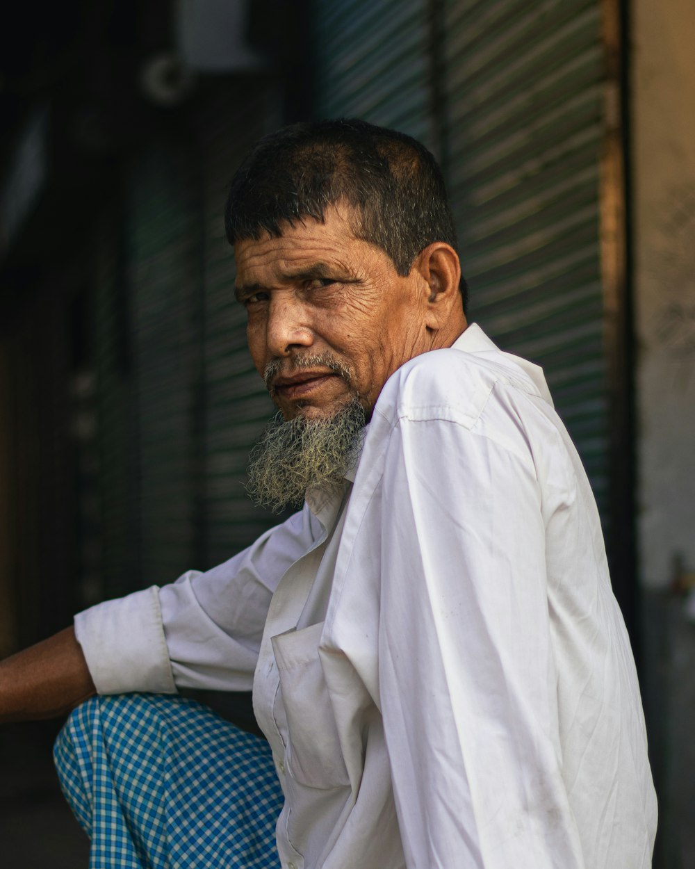 a man with a long beard sitting down