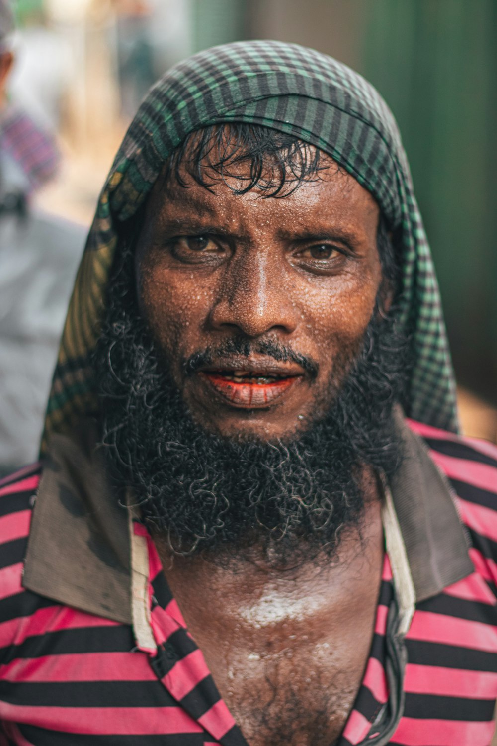 a man with a beard wearing a striped shirt