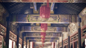a long hallway with red lanterns hanging from the ceiling