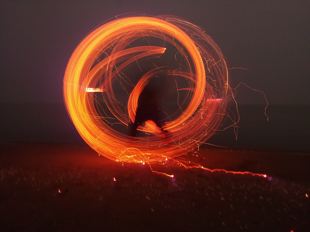 a blurry photo of a person spinning a circular object
