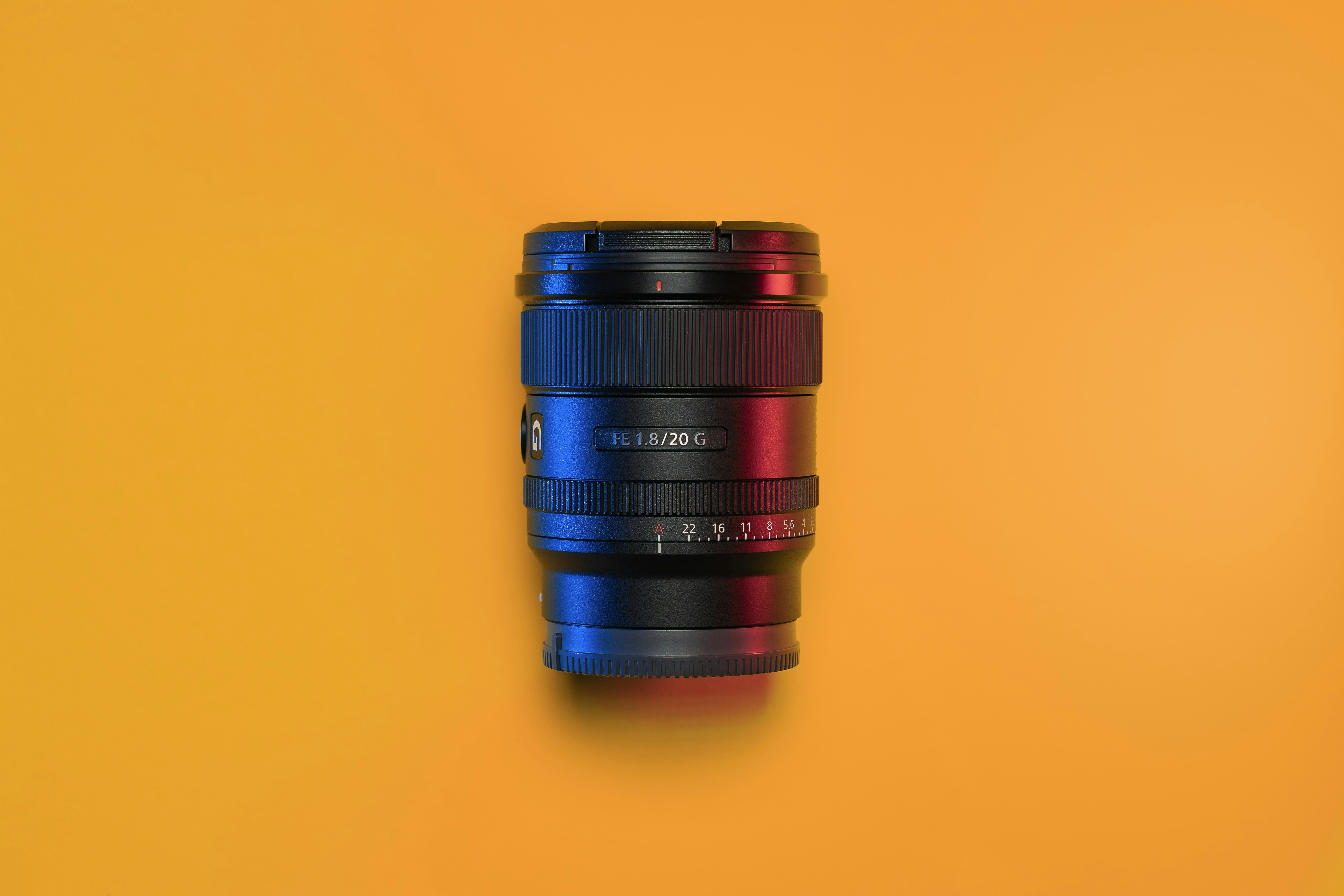 a close up of a camera lens on a yellow background