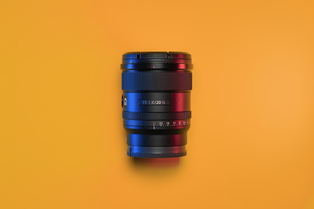 a close up of a camera lens on a yellow background