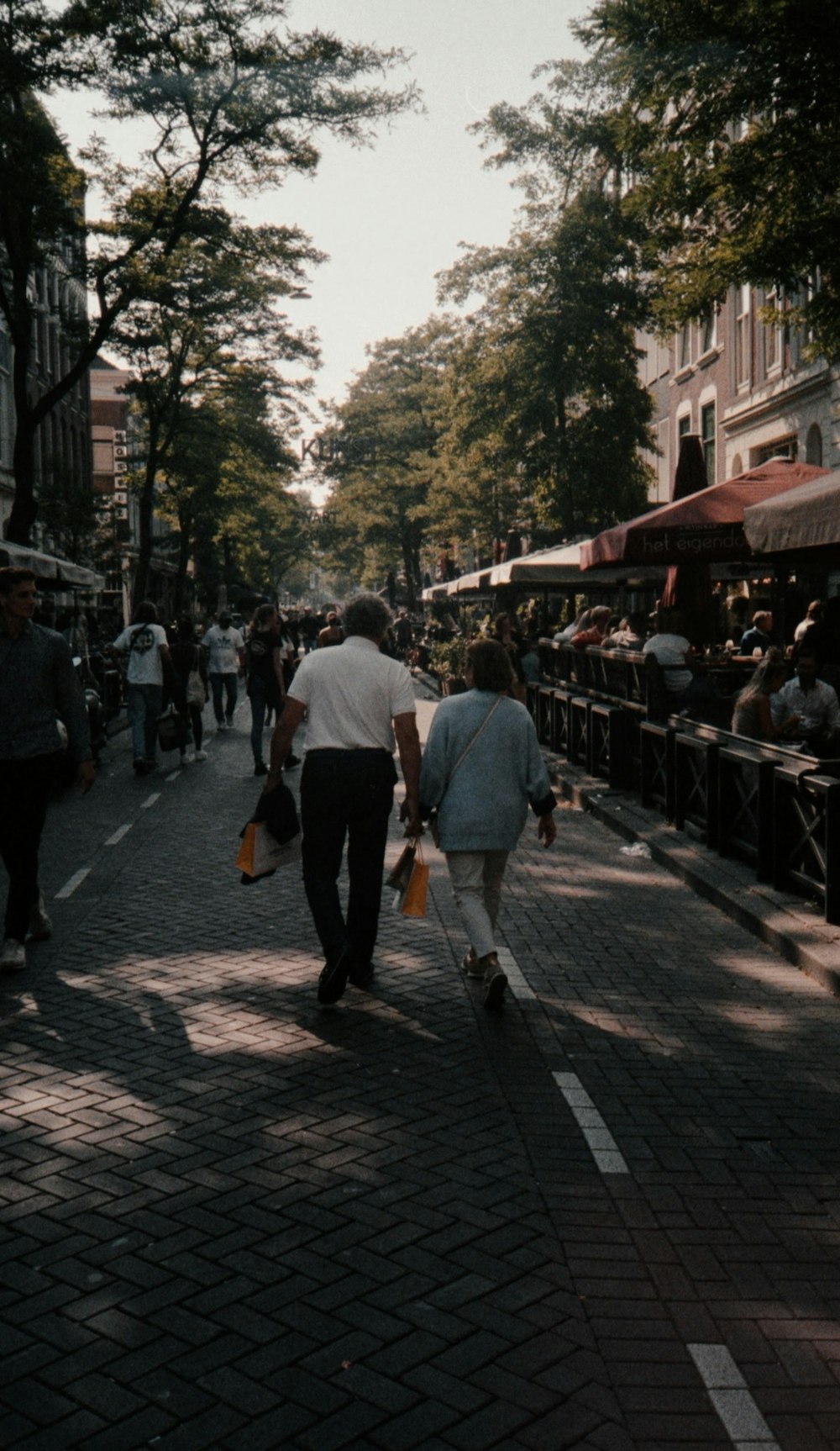 a couple of people walking down a street