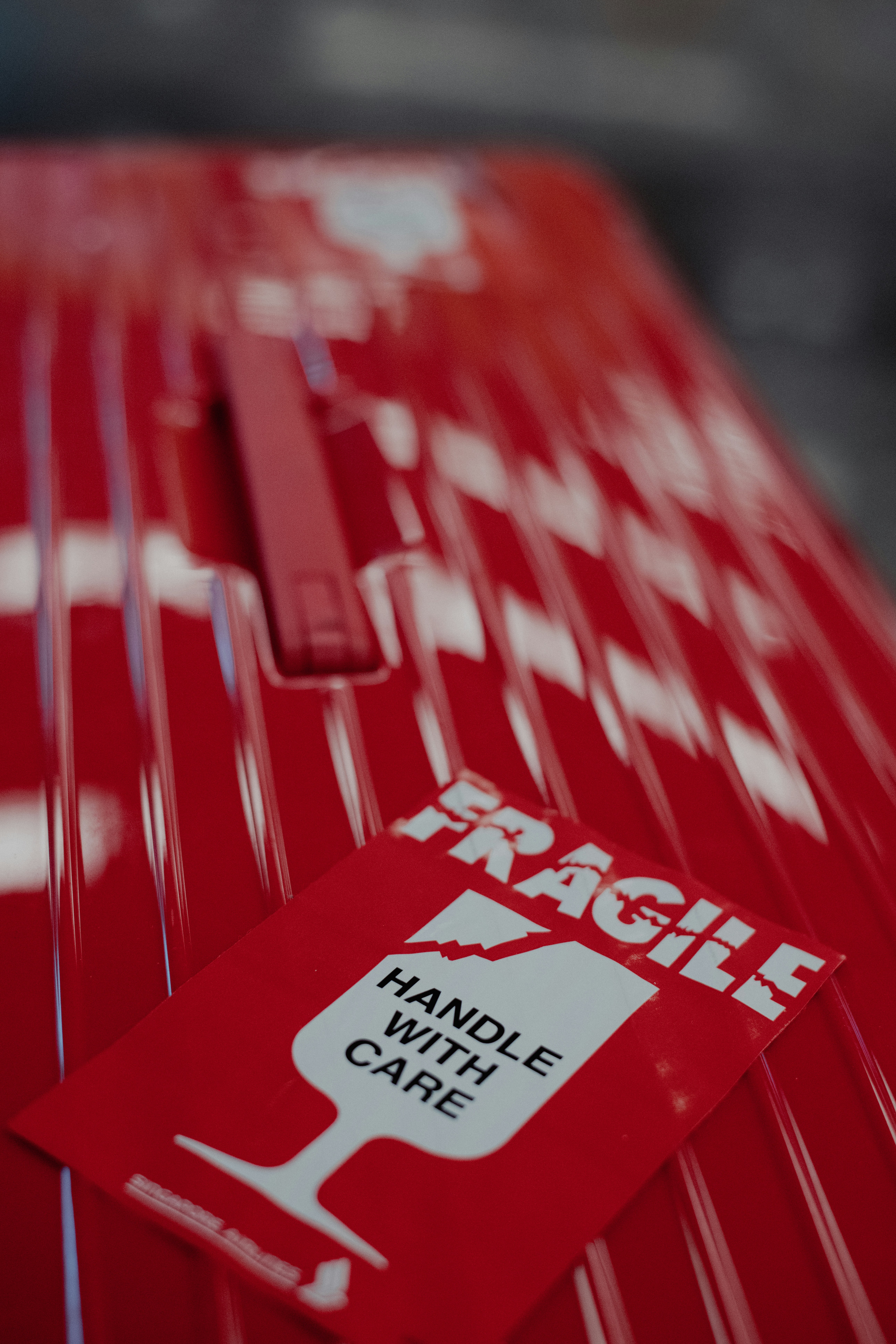 a close up of a red car with a sticker on it