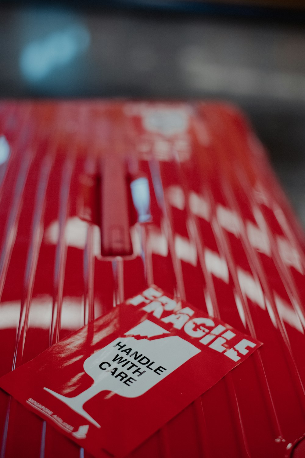 a red piece of luggage with a sticker on it