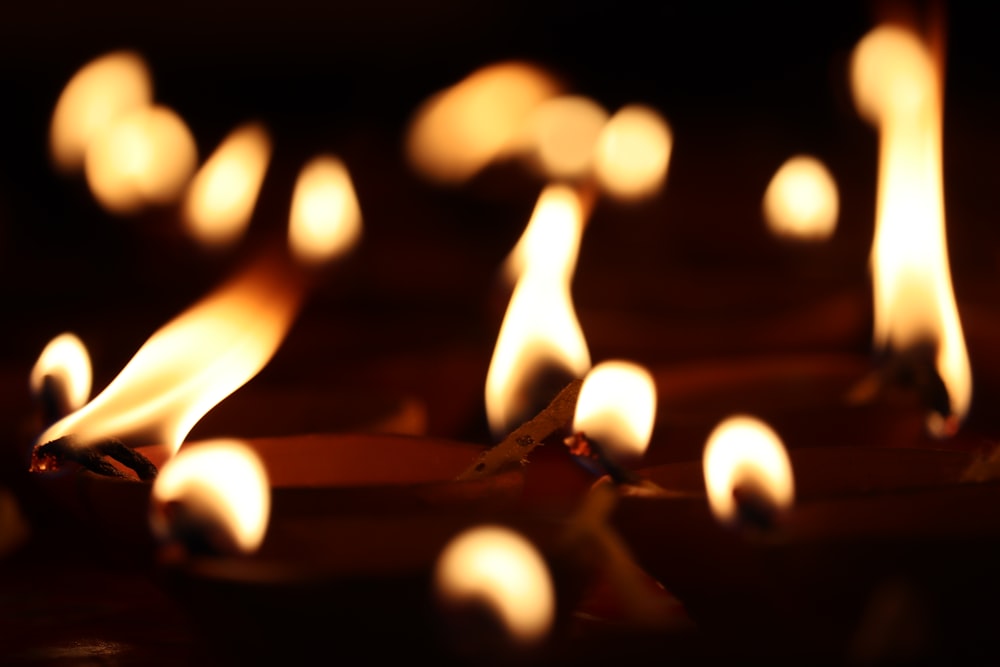 a group of lit candles sitting on top of a table